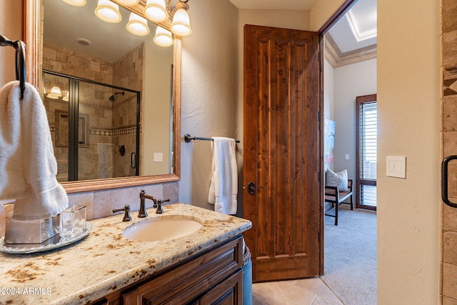 bathroom featuring ornamental molding, tile patterned flooring, walk in shower, and vanity