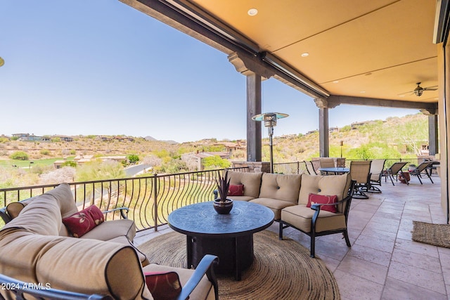 view of patio with a balcony, an outdoor hangout area, and ceiling fan