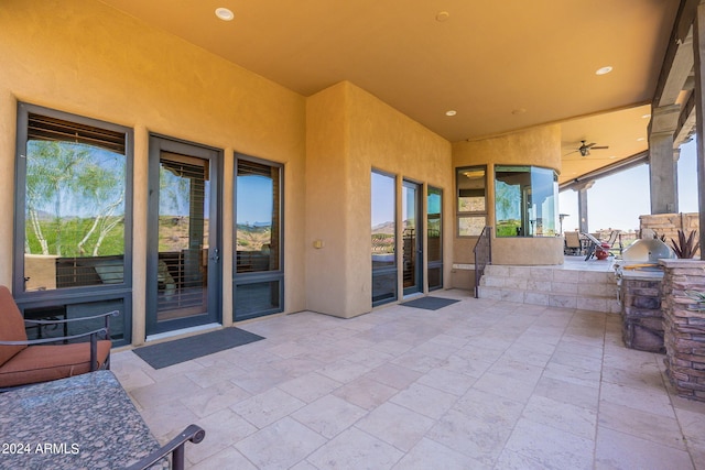 view of patio / terrace with ceiling fan and exterior kitchen