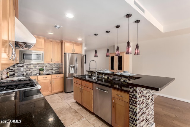 kitchen with light brown cabinetry, appliances with stainless steel finishes, a sink, and visible vents