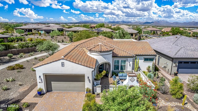 view of front of property featuring a mountain view and a garage