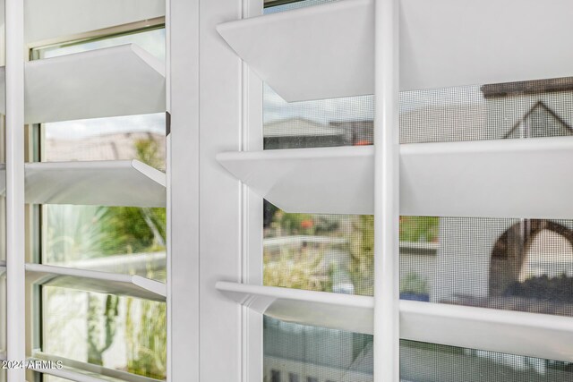 details featuring stainless steel refrigerator with ice dispenser and white cabinetry