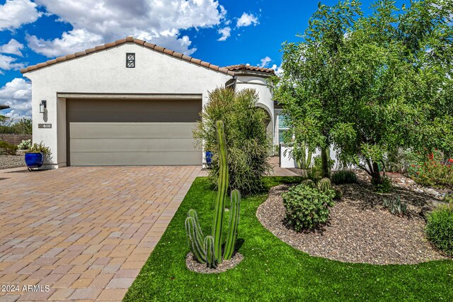 mediterranean / spanish-style house with a garage