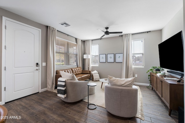 living room with dark wood-type flooring and ceiling fan