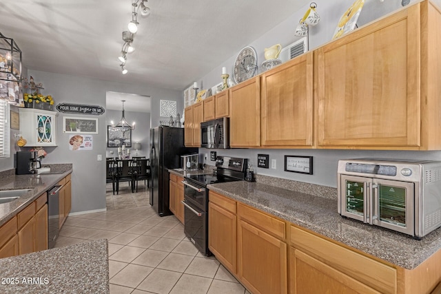 10566 E Bogart Ave, Mesa, AZ 85208 - kitchen with range with two ovens, light tile patterned floors, stainless steel dishwasher, freestanding refrigerator, and dark stone counters