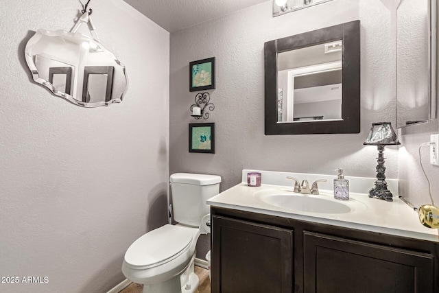 10566 E Bogart Ave, Mesa, AZ 85208 - half bath with vanity, toilet, a textured wall, and baseboards