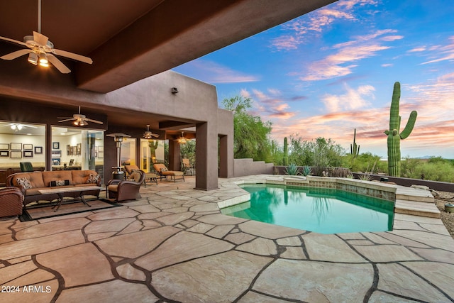 pool at dusk with an outdoor hangout area, a patio area, and ceiling fan