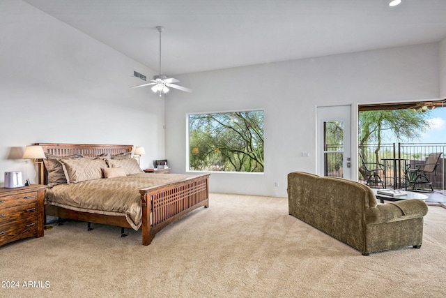 bedroom with ceiling fan, light carpet, multiple windows, and access to exterior