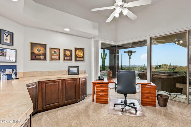 carpeted home office with ceiling fan