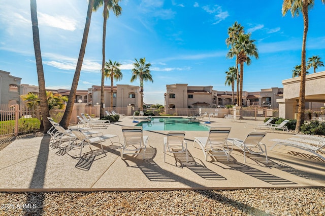 pool featuring a patio area, a residential view, and fence