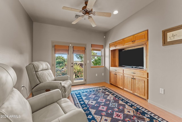 living room with ceiling fan, french doors, and light wood-type flooring