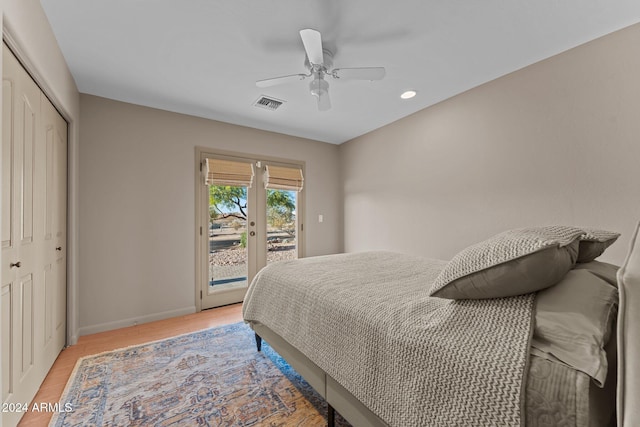 bedroom featuring ceiling fan, access to exterior, light wood-type flooring, and a closet