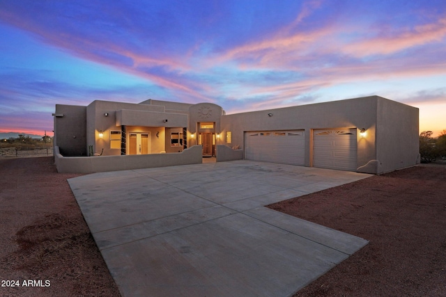 southwest-style home featuring a garage