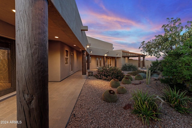 yard at dusk with a patio area