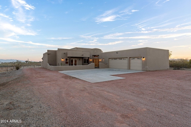 pueblo-style home with a garage