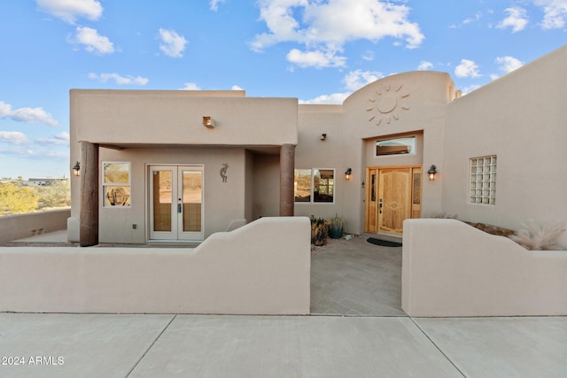 pueblo-style home featuring french doors