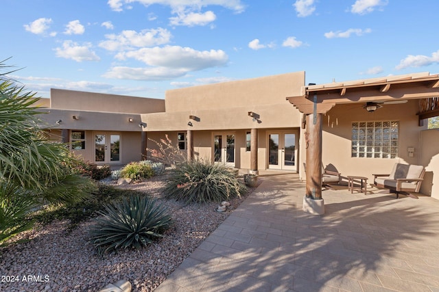 back of property with ceiling fan, a patio, and french doors