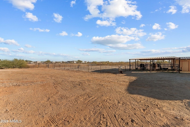 view of yard featuring a rural view and an outbuilding