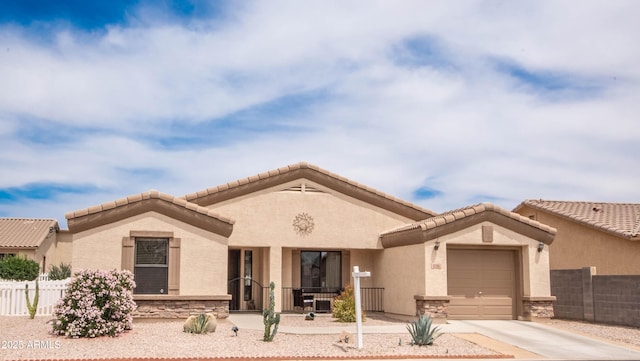 2101 S Meridian Rd Unit 176, Apache Junction, AZ 85120 - view of front of home with concrete driveway, a garage, stone siding, and stucco siding