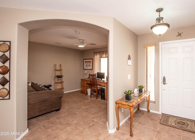 2101 S Meridian Rd Unit 176, Apache Junction, AZ 85120 - foyer with arched walkways, light tile patterned floors, ceiling fan, and baseboards