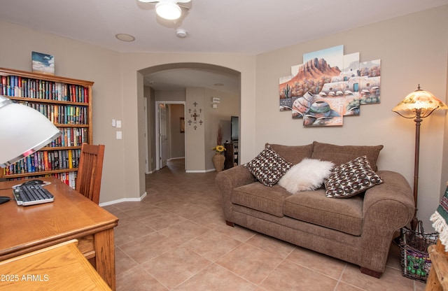 2101 S Meridian Rd Unit 176, Apache Junction, AZ 85120 - living area with arched walkways, light tile patterned flooring, ceiling fan, and baseboards
