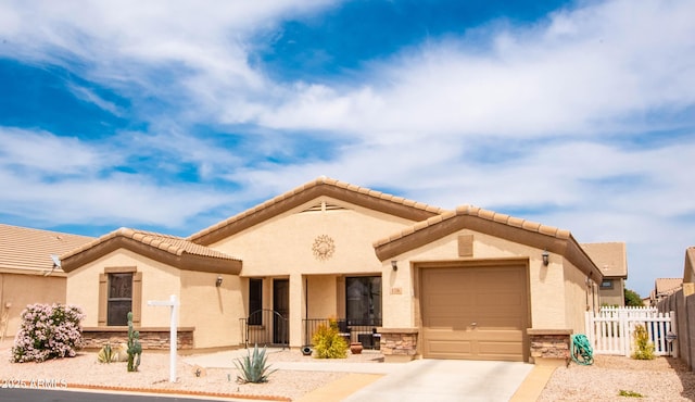 2101 S Meridian Rd Unit 176, Apache Junction, AZ 85120 - view of front facade featuring concrete driveway, a garage, stucco siding, and stone siding
