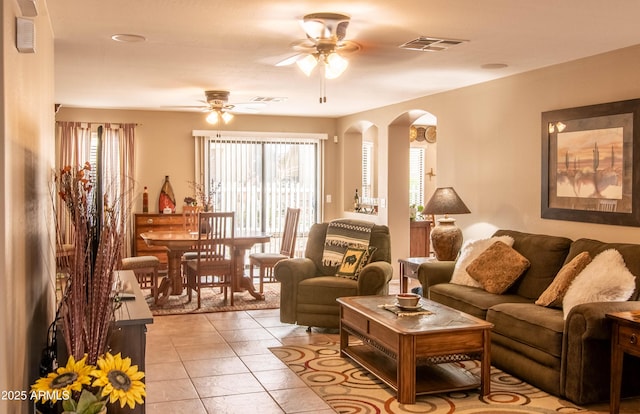 2101 S Meridian Rd Unit 176, Apache Junction, AZ 85120 - living area with arched walkways, a ceiling fan, and light tile patterned floors