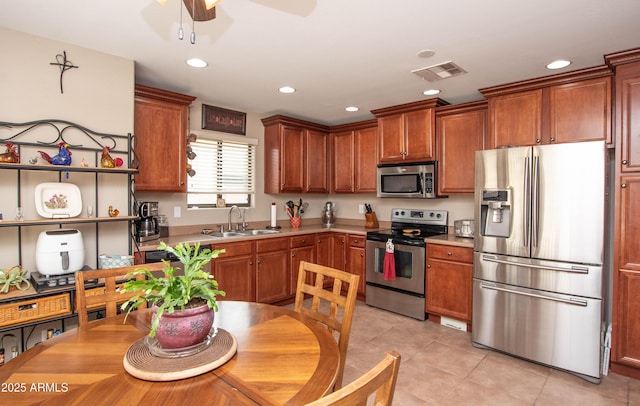 2101 S Meridian Rd Unit 176, Apache Junction, AZ 85120 - kitchen with appliances with stainless steel finishes, a sink, a ceiling fan, light tile patterned flooring, and light countertops