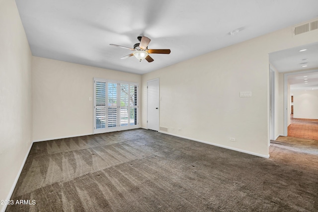 carpeted spare room with ceiling fan