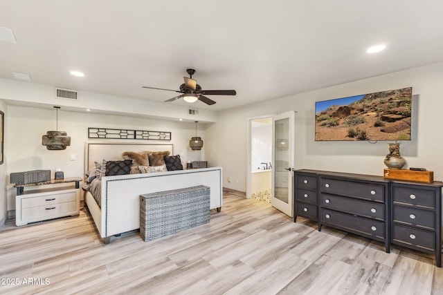 bedroom with connected bathroom, light hardwood / wood-style flooring, and ceiling fan