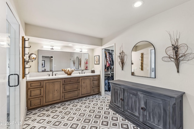 bathroom with vanity and a shower with door