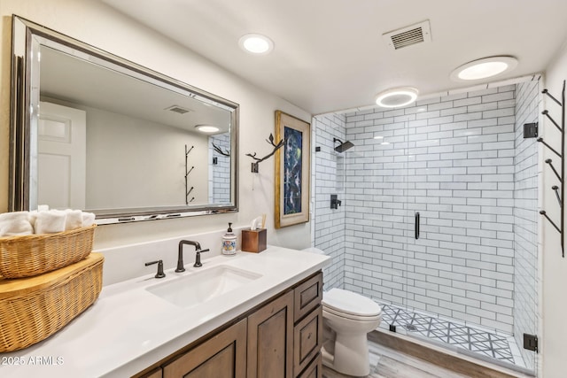 bathroom with walk in shower, vanity, toilet, and hardwood / wood-style flooring