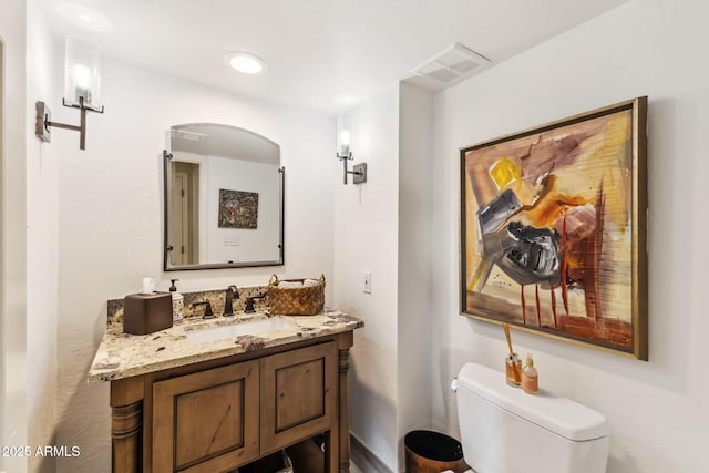 bathroom featuring vanity and toilet