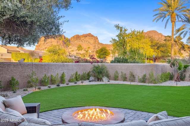 view of yard with an outdoor fire pit and a mountain view