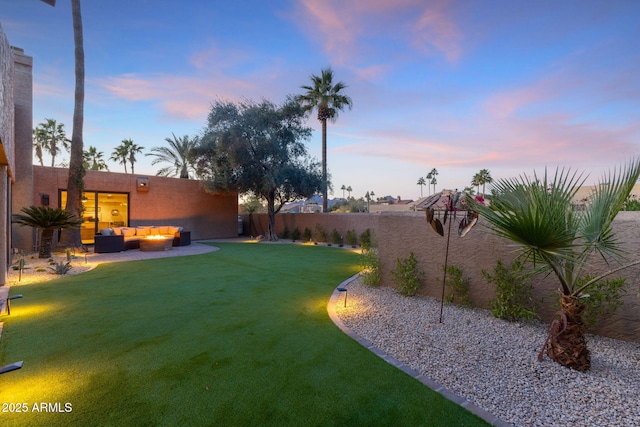 yard at dusk with an outdoor living space