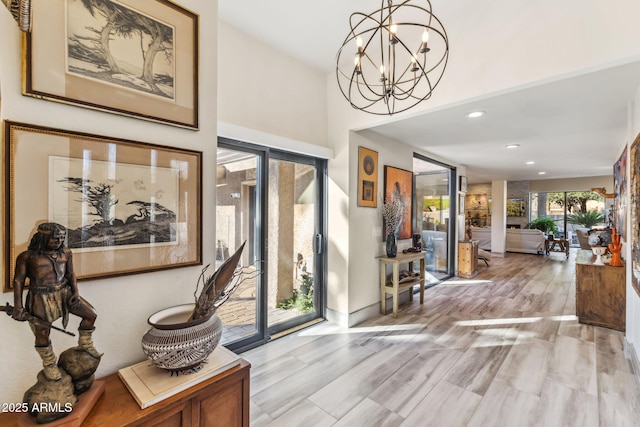 interior space with a notable chandelier and light wood-type flooring