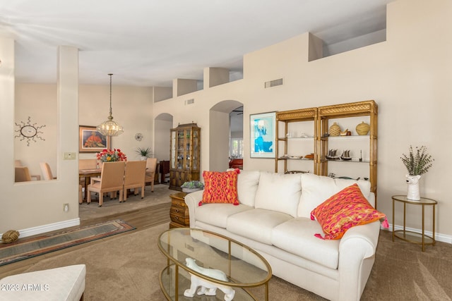 living room featuring carpet flooring and a high ceiling