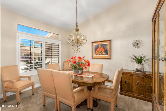 dining space featuring carpet floors and a chandelier