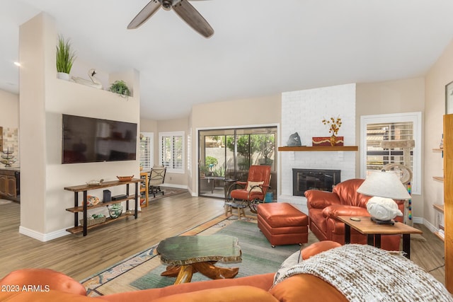 living room with ceiling fan, hardwood / wood-style floors, and a fireplace