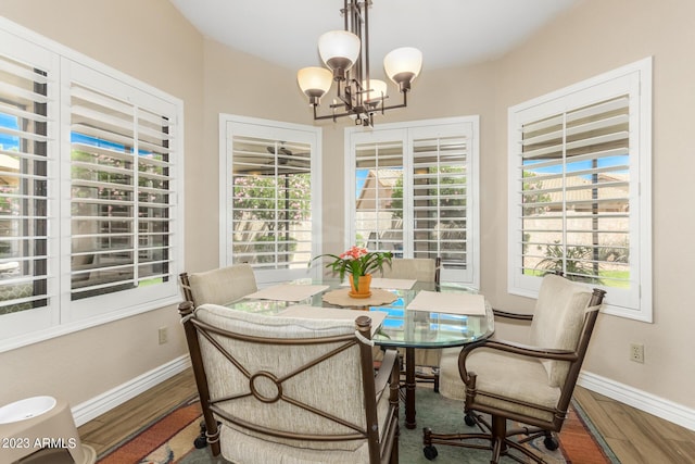 dining area with an inviting chandelier and wood-type flooring