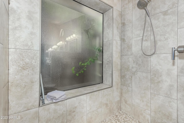 bathroom with a tile shower