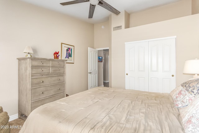 bedroom with ceiling fan, vaulted ceiling, and a closet