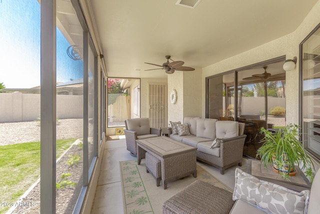 sunroom featuring ceiling fan