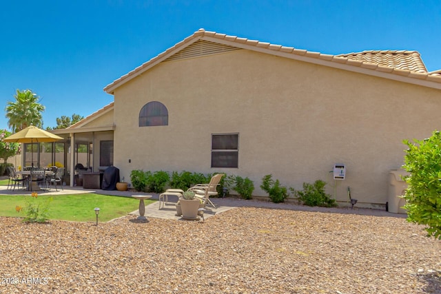 back of property featuring a patio