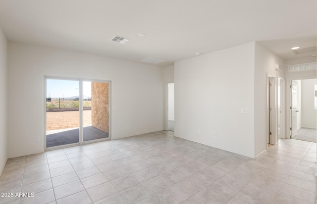 spare room featuring light tile patterned flooring