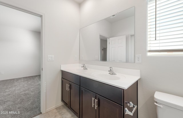 bathroom featuring vanity and toilet