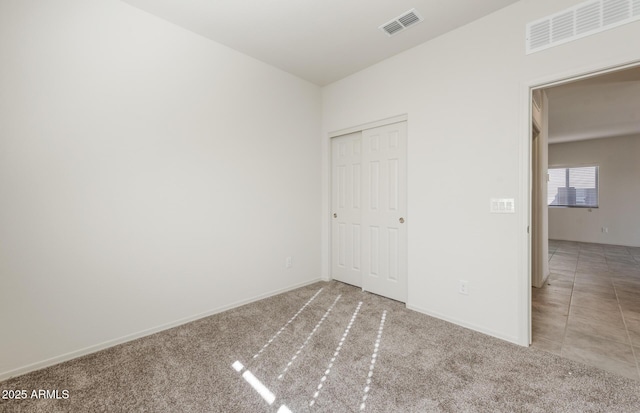 unfurnished bedroom with carpet and a closet