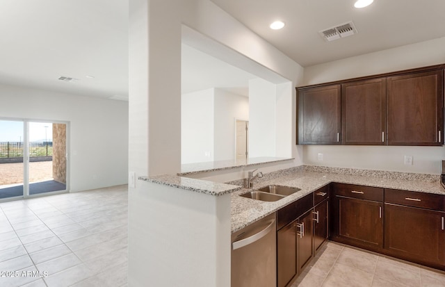 kitchen featuring sink, light stone counters, stainless steel dishwasher, and kitchen peninsula