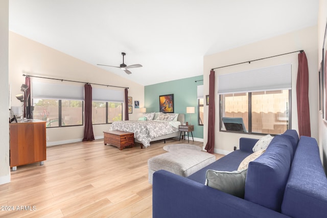 bedroom with ceiling fan, lofted ceiling, and light hardwood / wood-style flooring