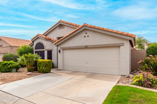 mediterranean / spanish-style home with a garage